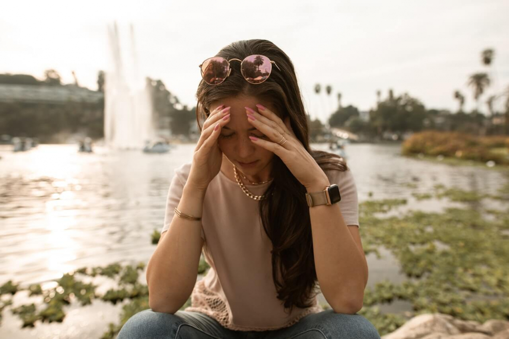 Distressed Woman Sitting on Lakeside