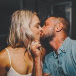 Man in Blue Button up Shirt Kissing Woman in White Spaghetti Strap Top