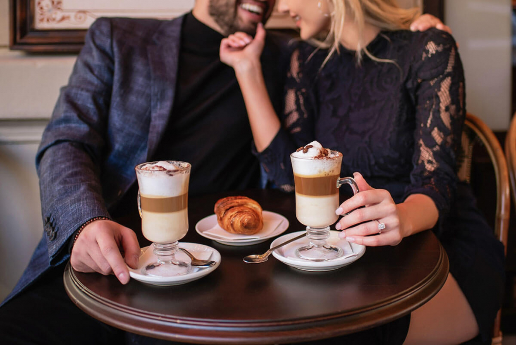 man in black shirt sitting beside woman in black shirt