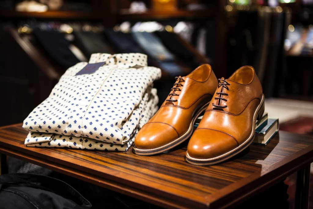 Pair of brown leather casual shoes on table