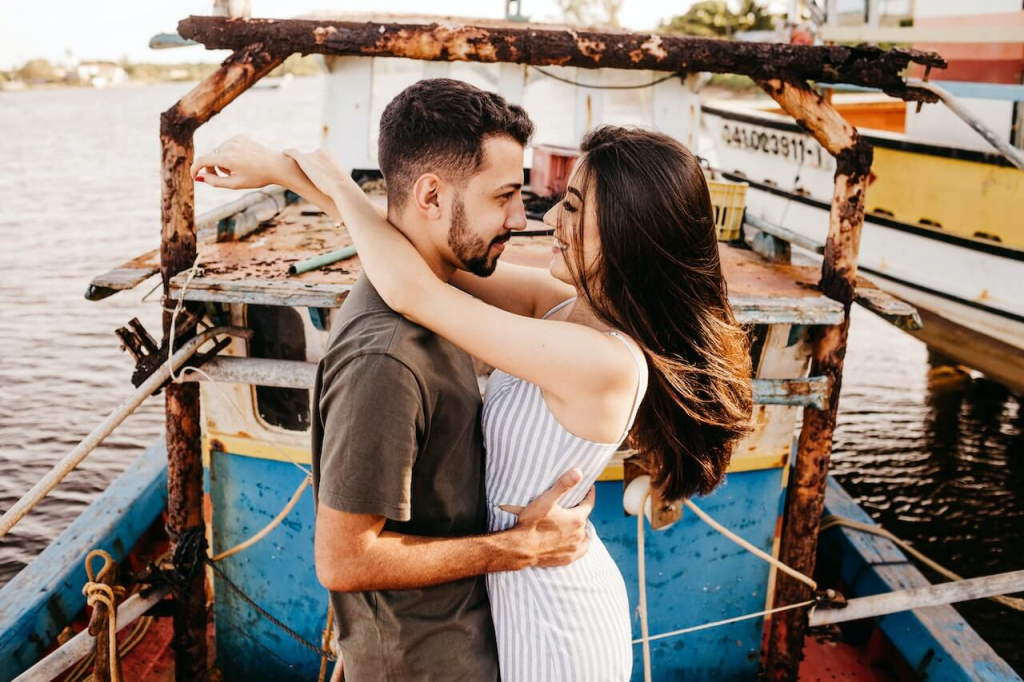 Joyful Couple Huggin on Weathered Boat